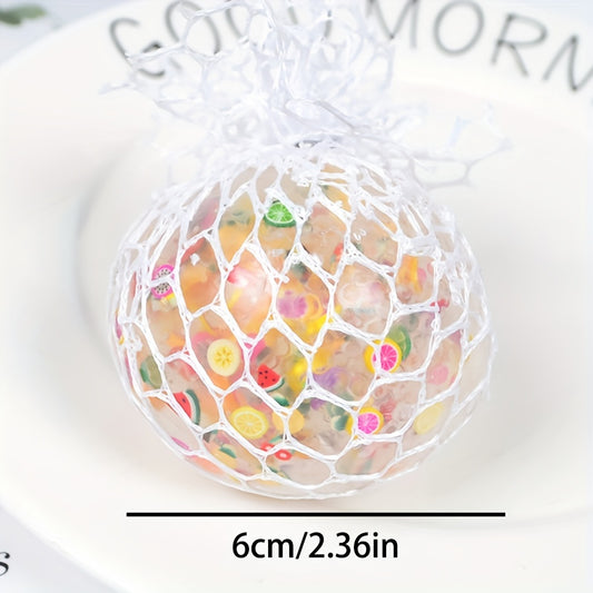 Hand squeezing a colorful orange fruit slice squishy stress ball, highlighting the pliable material and internal water beads for sensory relief.