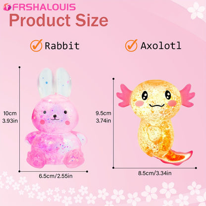 Two FRSHALOUIS glitter squishy fidgets, a pink rabbit and a blue axolotl, on a clean surface, emphasizing diverse designs.